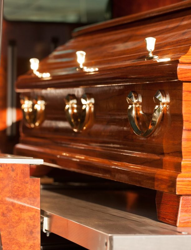 Funeral with coffin in hearse Dolor - Funeral with coffin on a cemetery in hearse