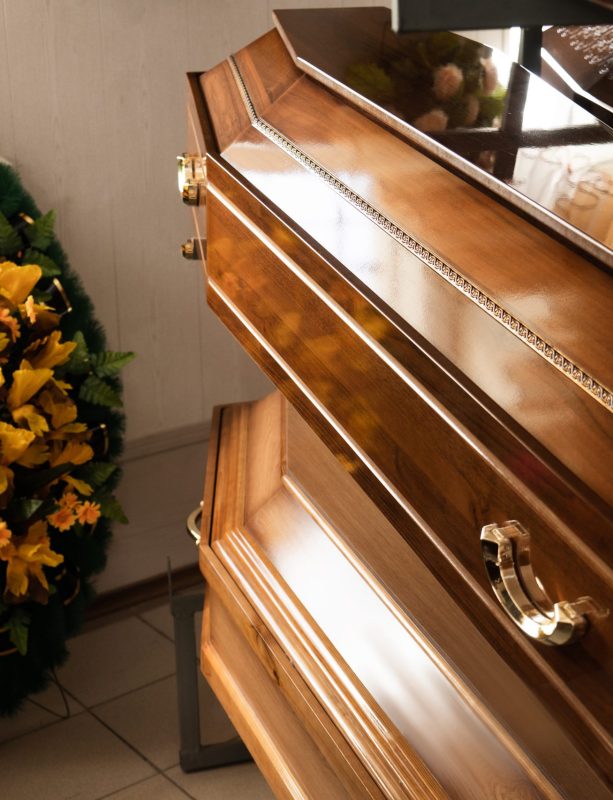 Production and manufacture of funeral goods. Coffins and wreaths close up Production and manufacture of funeral goods. Coffins and wreaths close up