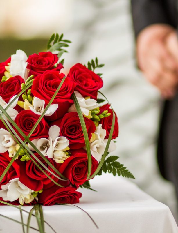 Wedding bouquet with red roses on the table A wedding bouquet with red roses on the table